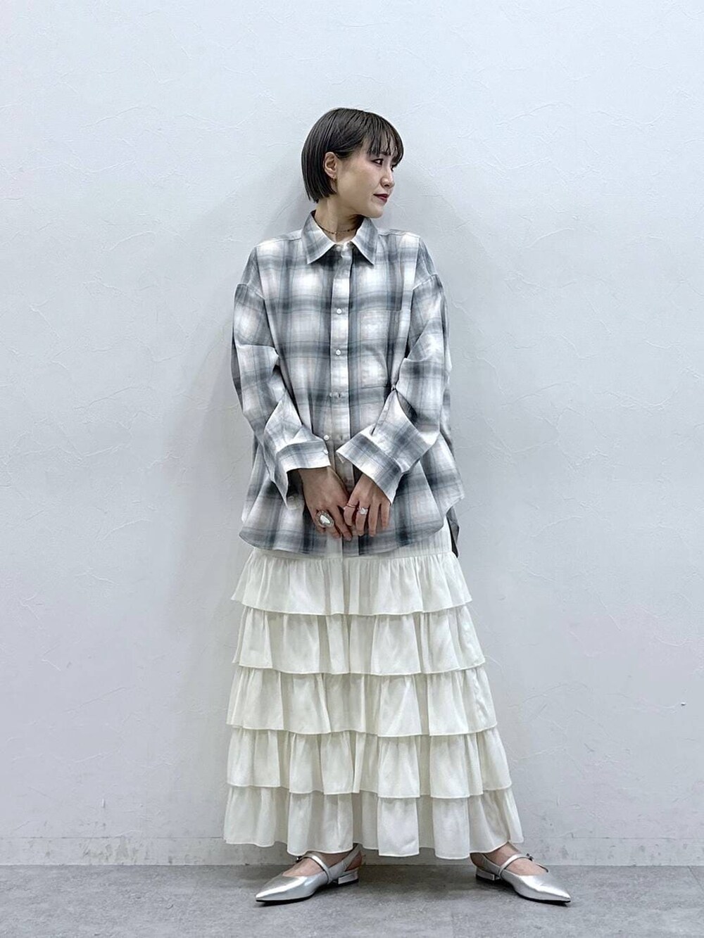 シルバー系のパンプス、ブルー系のシャツ/ブラウス、ホワイト系のスカートを着用したレディースの春コーディネートの2枚目の写真