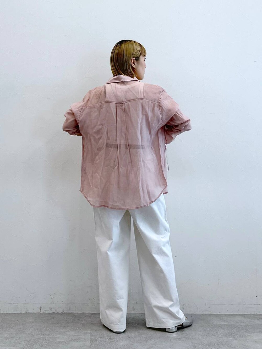 ピンク系のシャツ/ブラウス、ホワイト系のチノパンツを着用したレディースの夏コーディネートの3枚目の写真