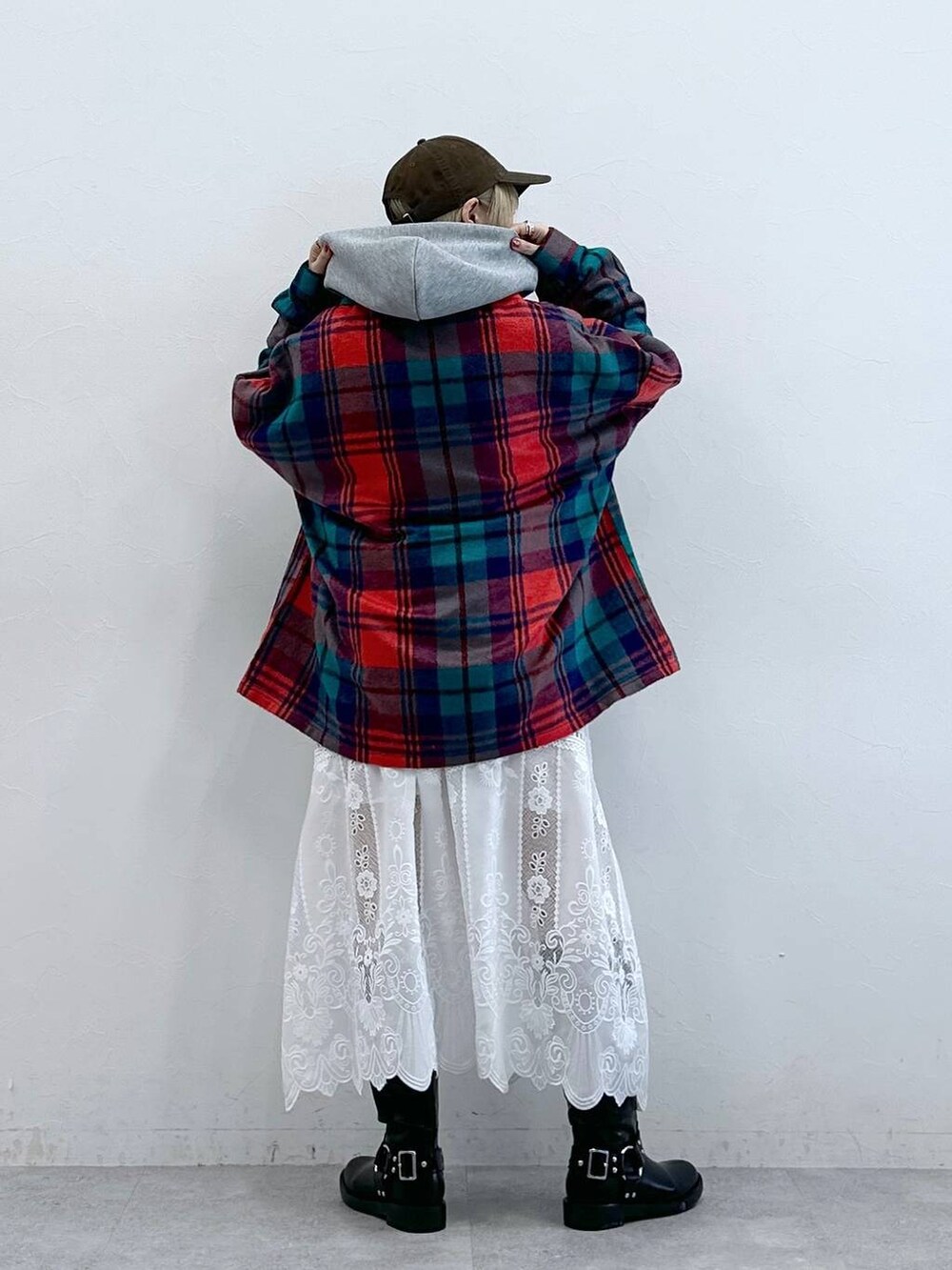 レッド系のシャツ/ブラウス、ブラック系のブーツ、ホワイト系のスカートを着用したレディースの秋コーディネートの6枚目の写真