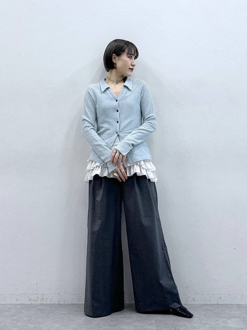 ホワイト系のキャミソール、グレー系のスラックス、ブルー系のカーディガン/ボレロを着用したレディースの春コーディネートの4枚目の写真