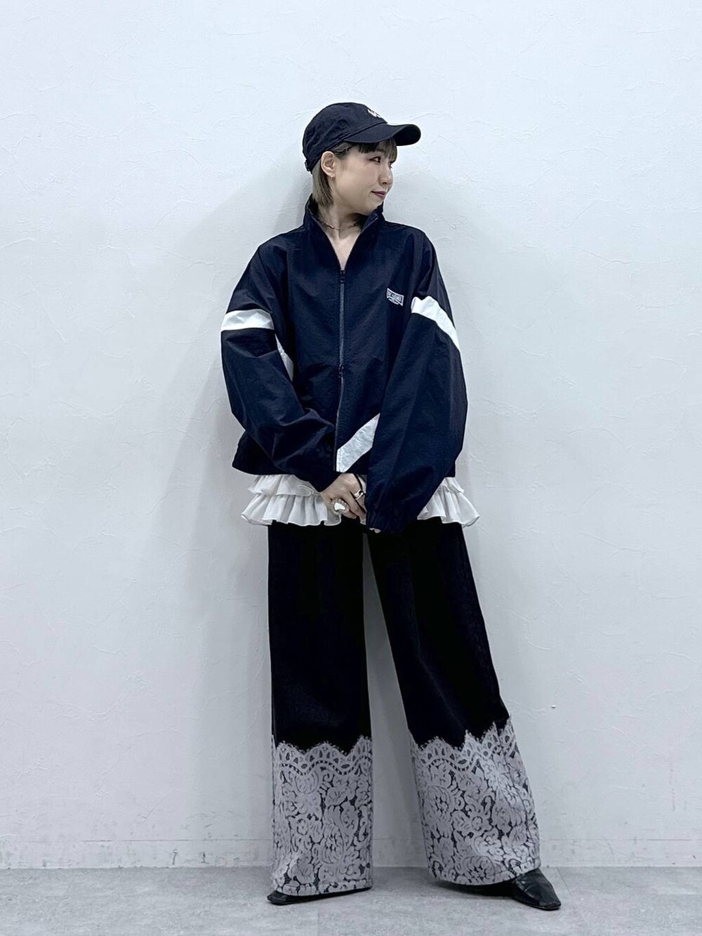 ホワイト系のキャミソール、ブルー系のブルゾン、ブラック系のデニムパンツを着用したレディースの冬コーディネートの3枚目の写真