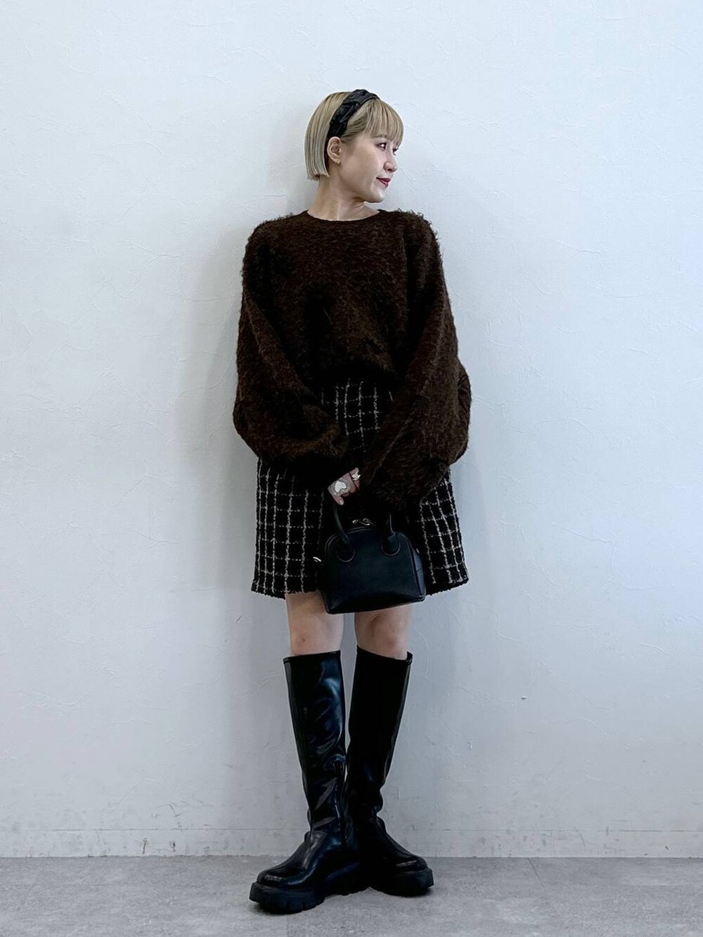 ブラック系のブーツ、ブラウン系のその他パンツ、ブラウン系のニット/セーターを着用したレディースの冬コーディネートの6枚目の写真