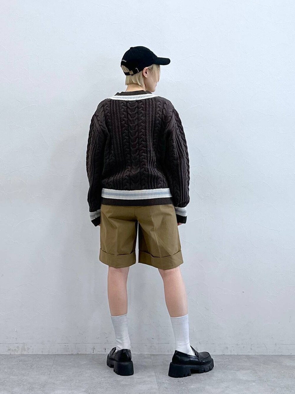 ブラック系のローファー、ブラウン系のニット/セーター、ブラウン系のチノパンツを着用したレディースの秋コーディネートの6枚目の写真