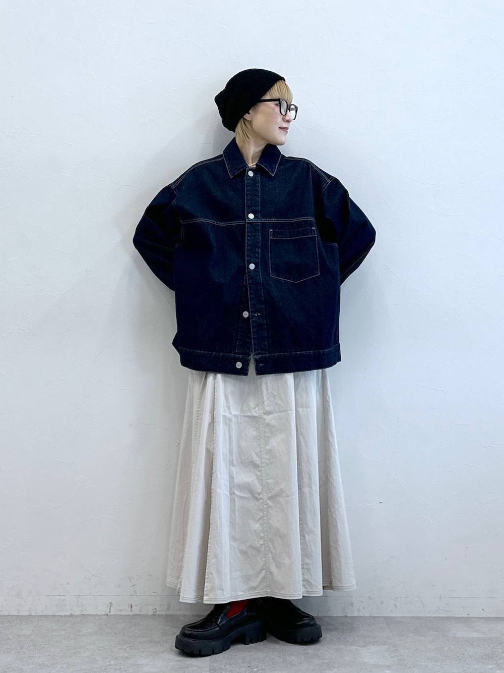 ブラック系のローファー、ブルー系のデニムジャケット、ホワイト系のスカートを着用したレディースの夏コーディネートの4枚目の写真