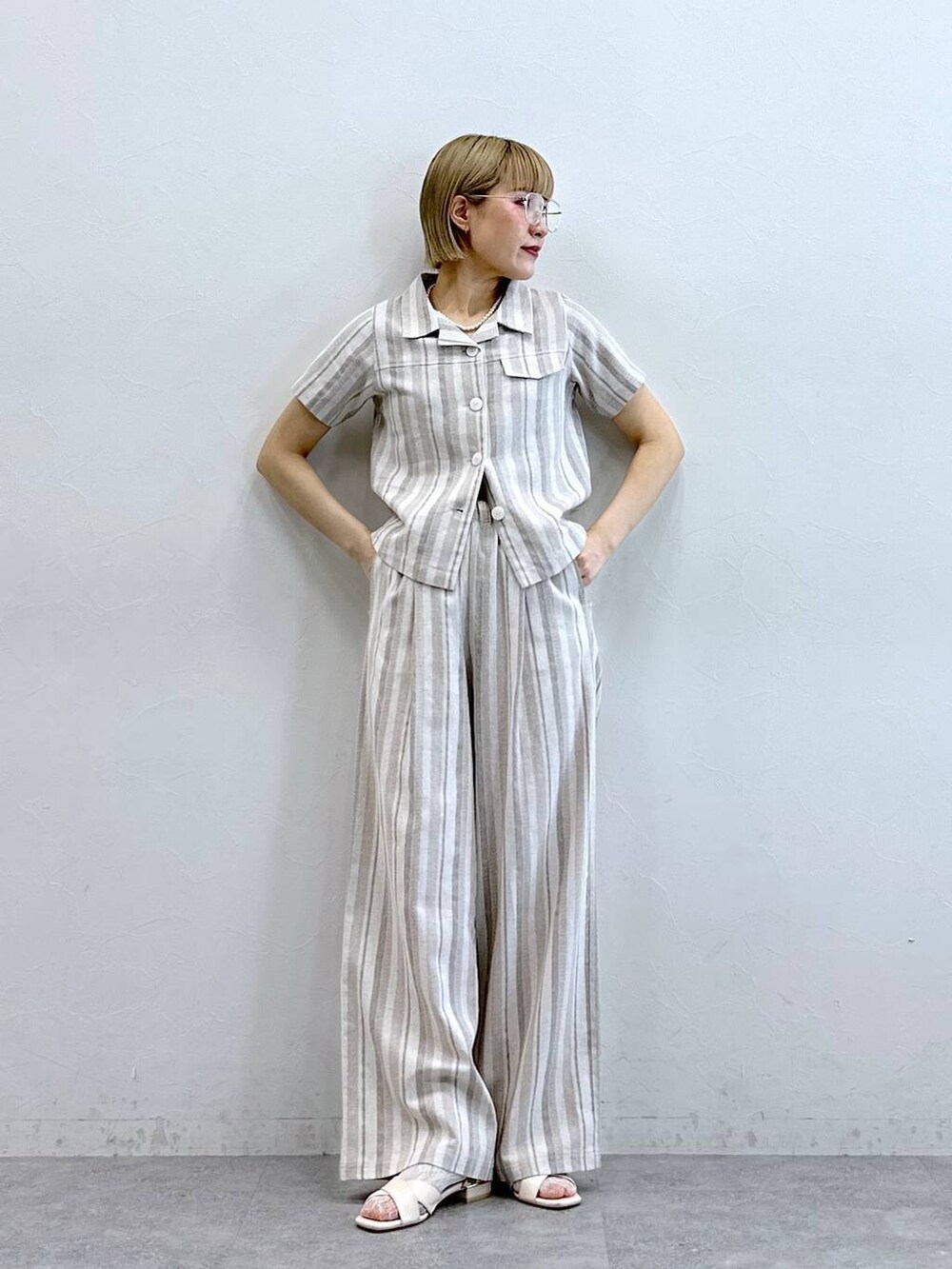 ベージュ系のシャツ/ブラウス、ベージュ系のその他パンツ、ブラック系のメガネを着用したレディースの夏コーディネートの4枚目の写真