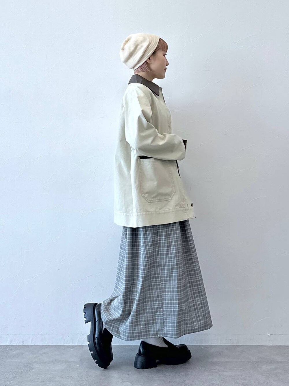 ブラック系のローファー、ホワイト系のブルゾン、グレー系のワンピースを着用したレディースの冬コーディネートの5枚目の写真