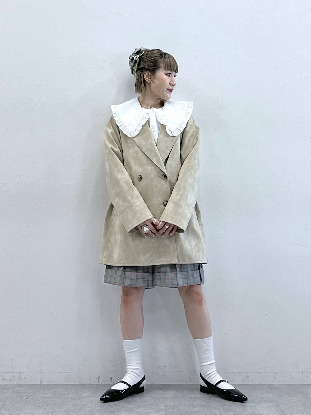 ホワイト系のシャツ/ブラウス、ブラック系のパンプス、ベージュ系のスラックスを着用したレディースの冬コーディネートの2枚目の写真