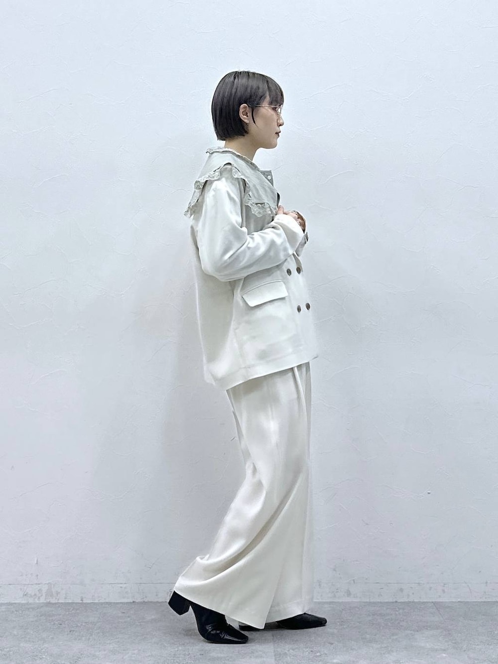 グリーン系のシャツ/ブラウス、ホワイト系のテーラードジャケット、ホワイト系のスラックスを着用したレディースの春コーディネートの5枚目の写真