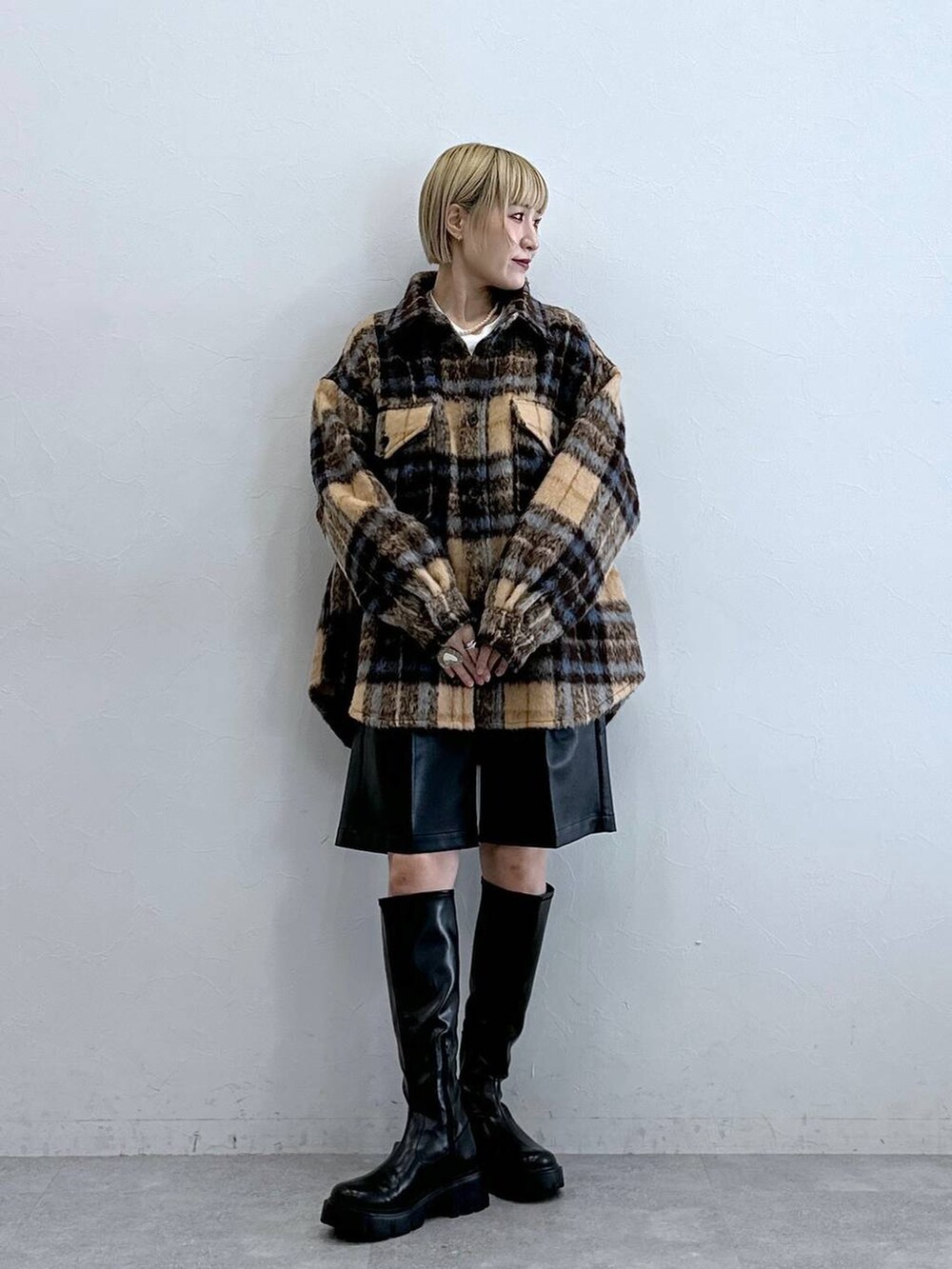 ブラック系のブーツ、ブラック系のスラックス、ブラウン系のブルゾンを着用したレディースの秋コーディネートの3枚目の写真