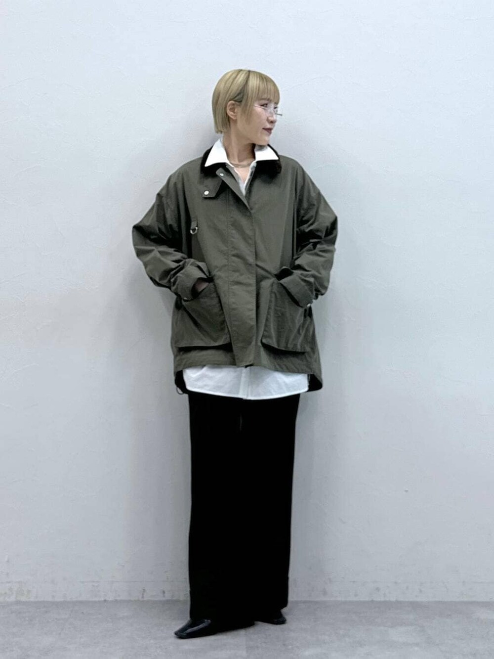 ホワイト系のシャツ/ブラウス、ブラウン系のスラックスを着用したレディースの冬コーディネートの3枚目の写真