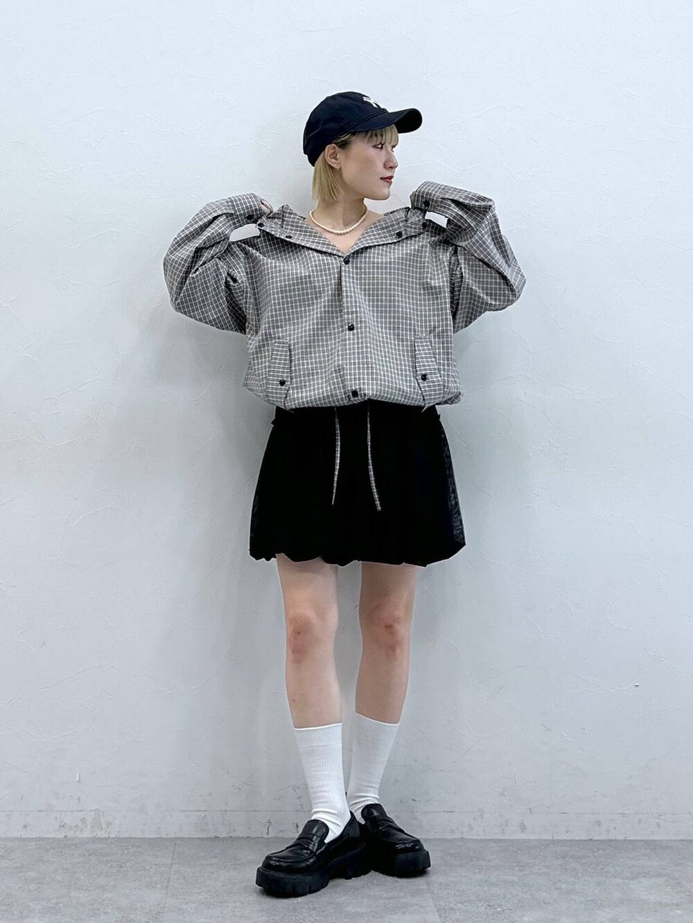 ブラック系のローファー、ブラック系のスカート、グレー系のシャツ/ブラウスを着用したレディースの夏コーディネートの3枚目の写真