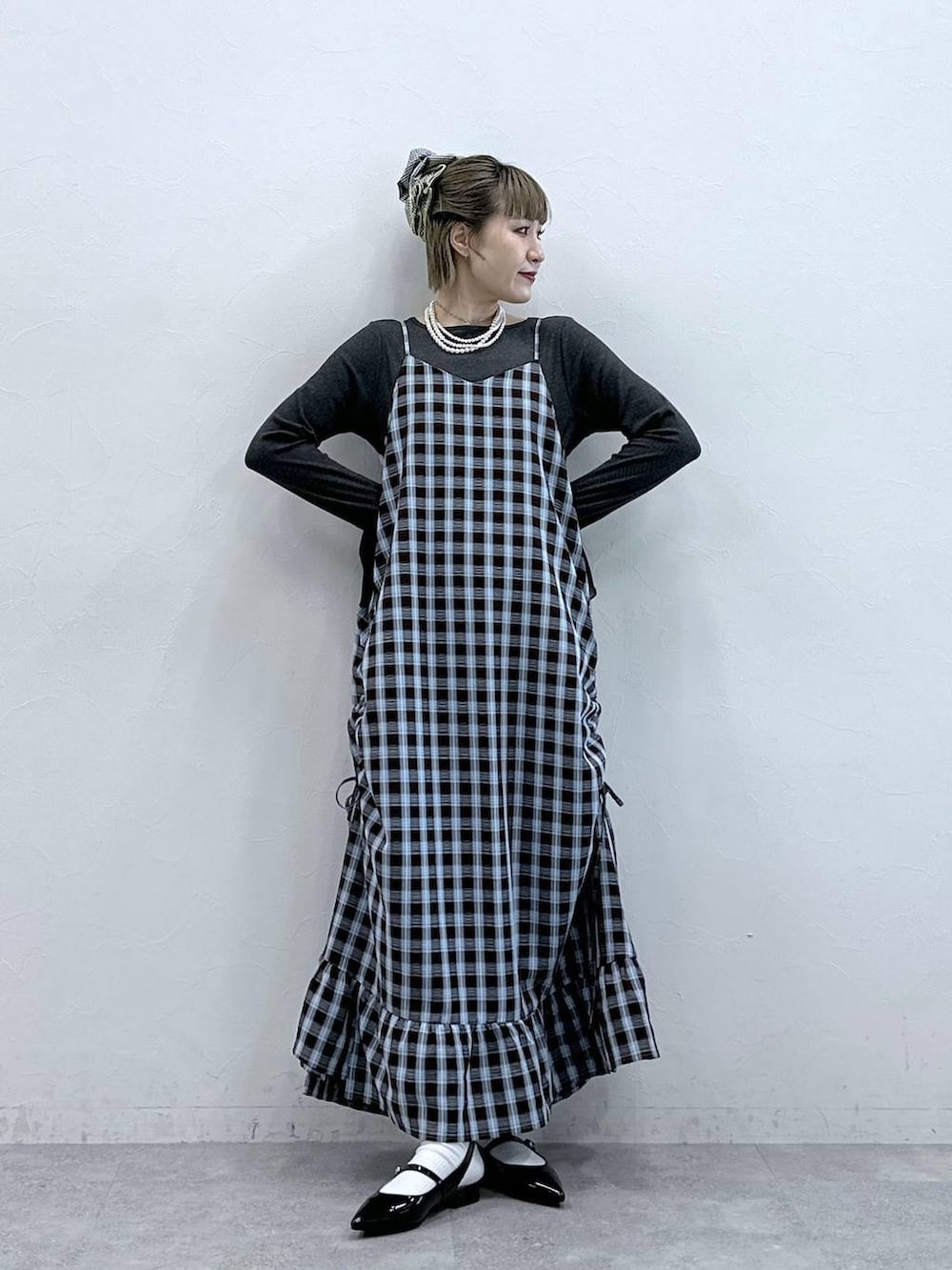 ブラック系のパンプス、ブラウン系のワンピース、グレー系のTシャツ/カットソーを着用したレディースの冬コーディネートの2枚目の写真