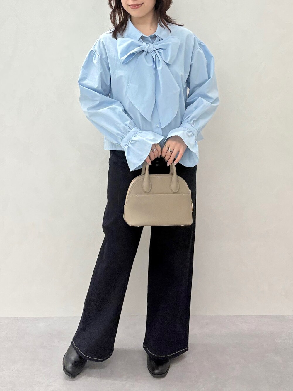 ブルー系のデニムパンツ、ブラック系のカーディガン/ボレロ、ブルー系のシャツ/ブラウスを着用したレディースの秋コーディネートの5枚目の写真