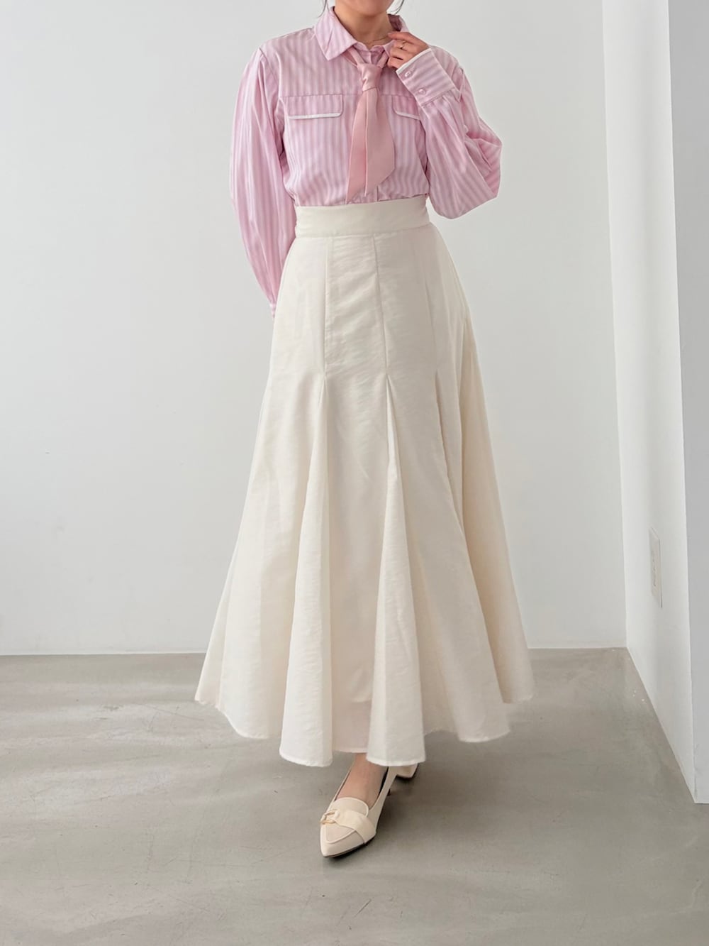 ピンク系のシャツ/ブラウス、ホワイト系のスカートを着用したレディースの春コーディネートの2枚目の写真