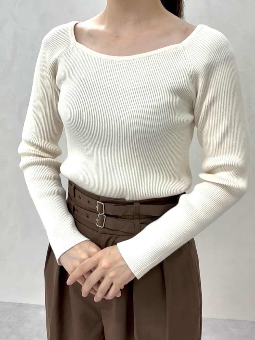 ベージュ系のニット/セーター、ブラウン系のスラックス、ブラウン系のパンプスを着用したレディースの秋コーディネートの5枚目の写真