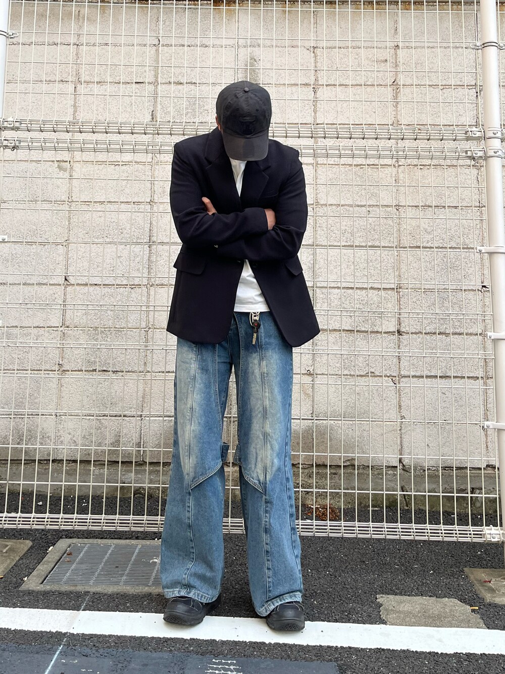 ブルー系のデニムパンツ、ホワイト系のTシャツ/カットソー、ブラック系のジャケット/アウターを着用したメンズの秋コーディネートの2枚目の写真