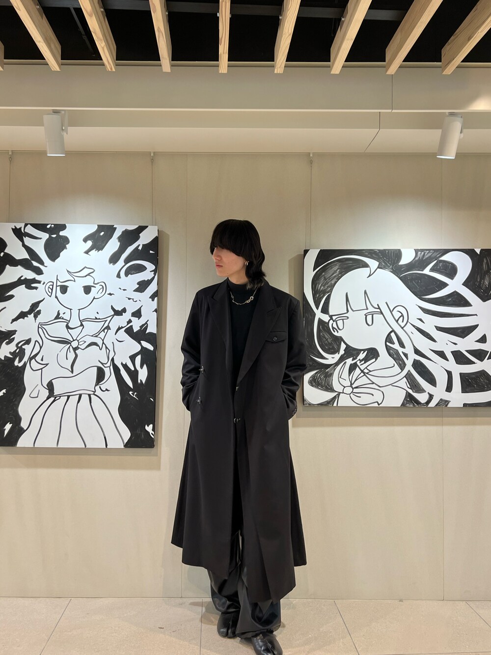 ブラック系のTシャツ/カットソー、ブラック系のチェスターコート、ブラック系のその他パンツを着用したメンズの冬コーディネートの2枚目の写真