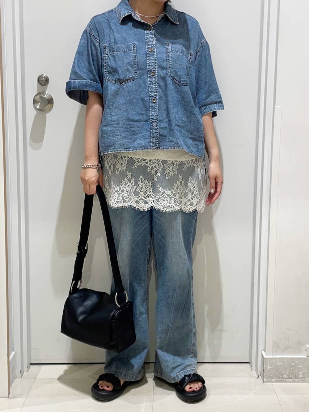 ブルー系のデニムパンツ、ホワイト系のキャミソール、ブルー系のシャツ/ブラウスを着用したレディースの夏コーディネートの2枚目の写真