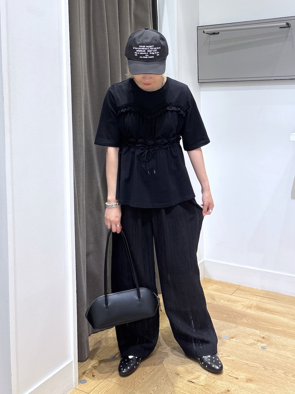 ブラック系のその他パンツ、ブラック系のTシャツ/カットソー、ブラック系のボストンバッグを着用したレディースの春コーディネートの3枚目の写真