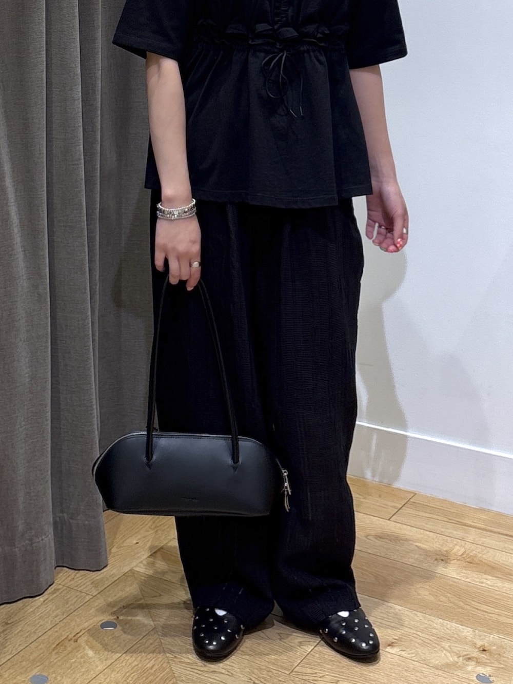 ブラック系のその他パンツ、ブラック系のTシャツ/カットソー、ブラック系のボストンバッグを着用したレディースの春コーディネートの8枚目の写真