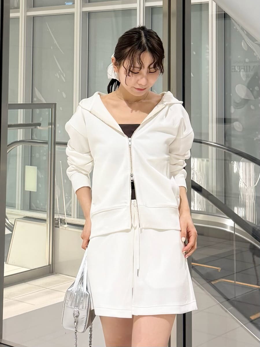 ブラウン系のブーツ、シルバー系のハンドバッグ、ホワイト系のパーカーを着用したレディースの冬コーディネートの10枚目の写真