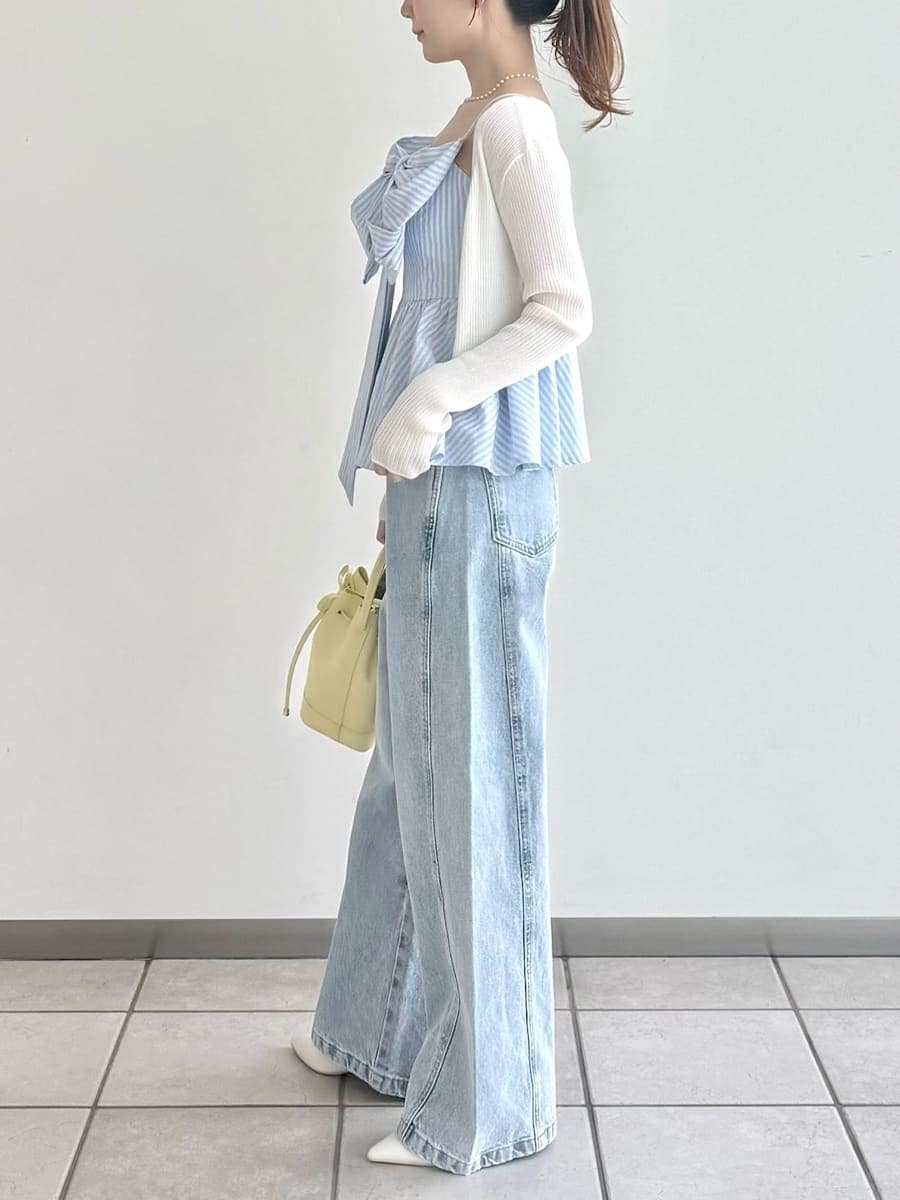 イエロー系のハンドバッグ、その他のキャミソール、ホワイト系のカーディガン/ボレロを着用したレディースの春コーディネートの4枚目の写真