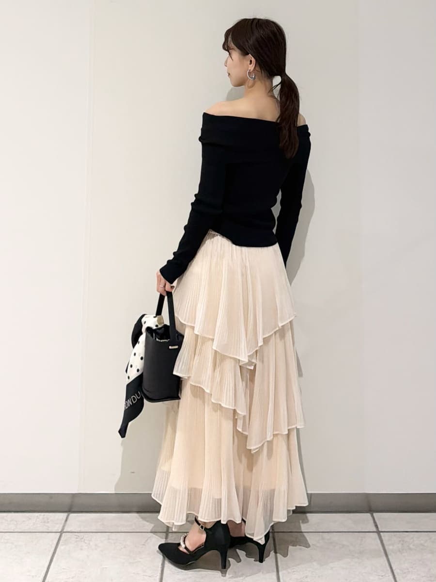 ベージュ系のスカート、ベージュ系のトレンチコート、ブラック系のニット/セーターを着用したレディースの冬コーディネートの4枚目の写真