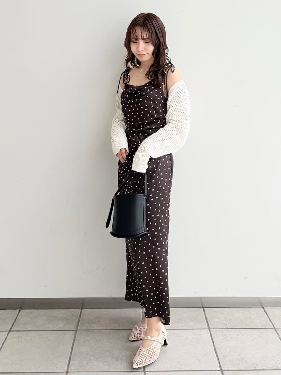 ブラウン系のワンピース、ホワイト系のカーディガン/ボレロ、ブラック系のハンドバッグを着用したレディースの冬コーディネートの8枚目の写真