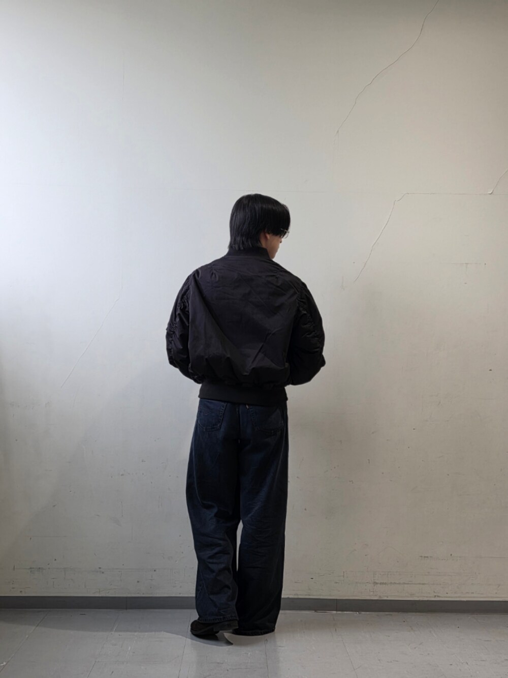 ブラック系のTシャツ/カットソー、ブラック系のデニムパンツ、ブラウン系のドレスシューズを着用したメンズの秋コーディネートの5枚目の写真