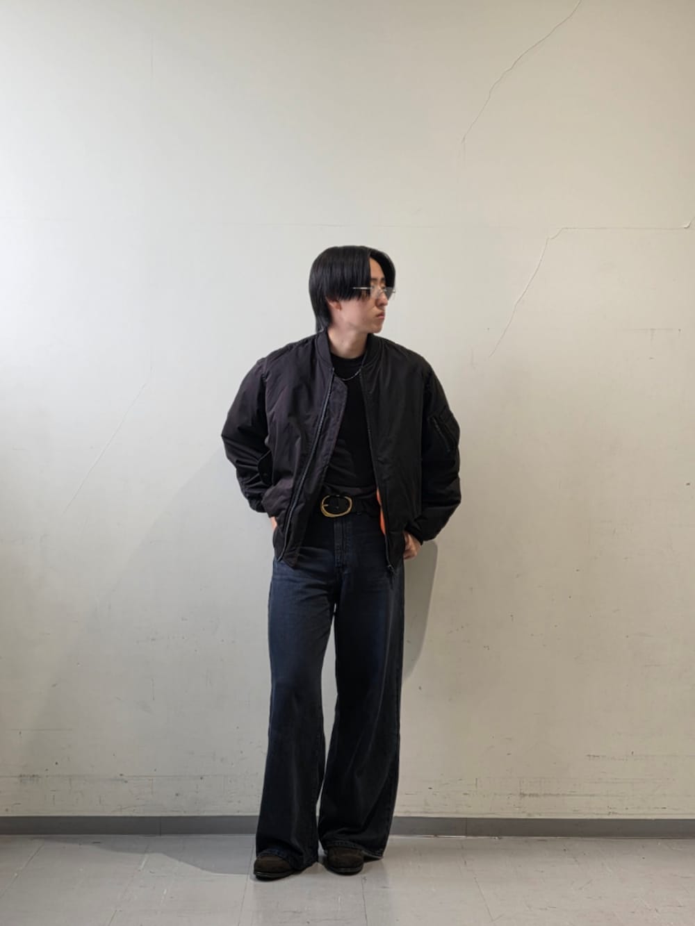 ブラック系のTシャツ/カットソー、ブラック系のデニムパンツ、ブラウン系のドレスシューズを着用したメンズの秋コーディネートの2枚目の写真