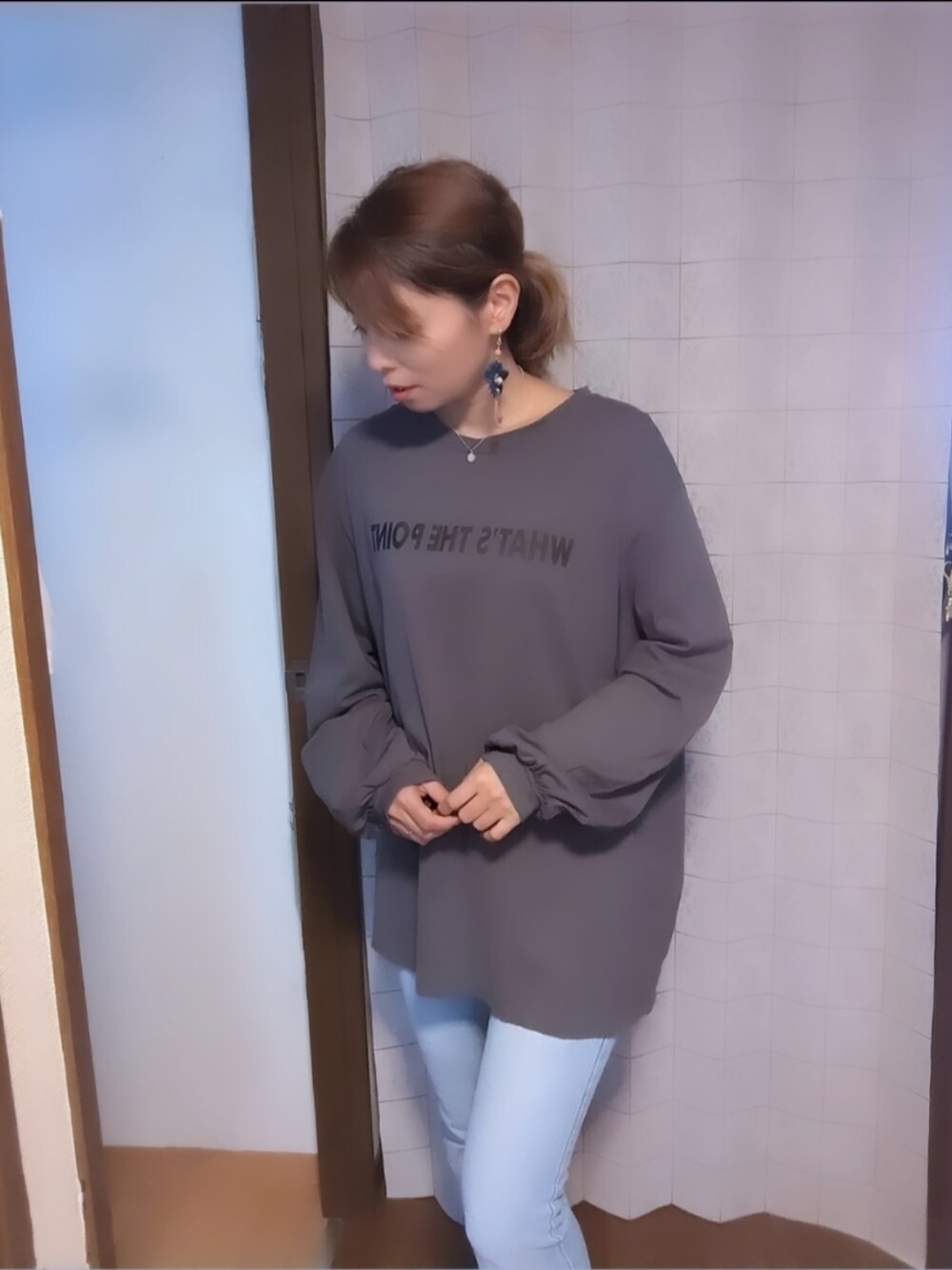 グレー系のトップス、シルバー系のネックレスを着用したレディースの秋コーディネートの4枚目の写真