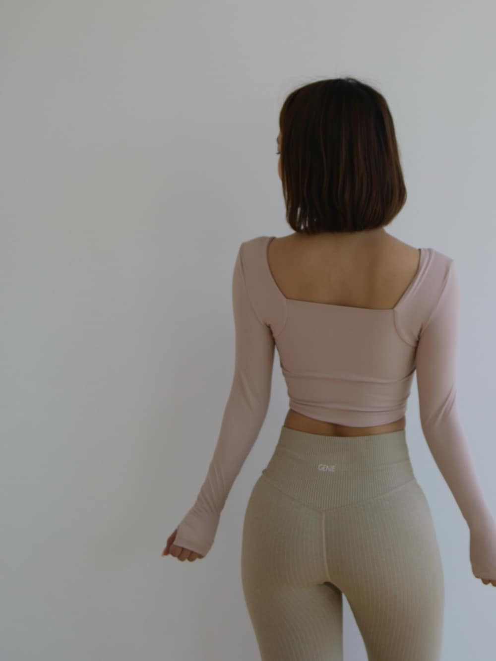 ピンク系のトップス、ベージュ系のパンツを着用したレディースの夏コーディネートの3枚目の写真