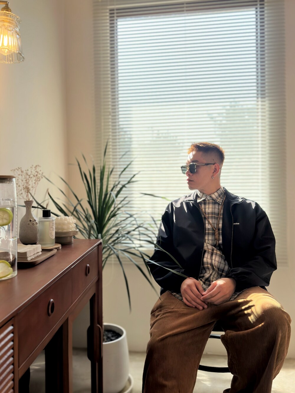 ブラック系のジャケット/アウター、ブラック系のスニーカー、グリーン系のサングラスを着用したメンズの冬コーディネートの4枚目の写真