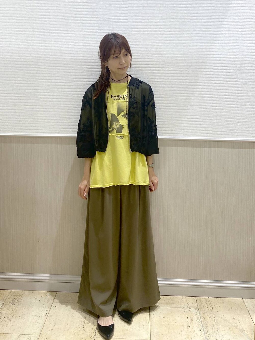 ブラック系のパンプス、ブラック系のブルゾン、イエロー系のTシャツ/カットソーを着用したレディースの春コーディネートの5枚目の写真