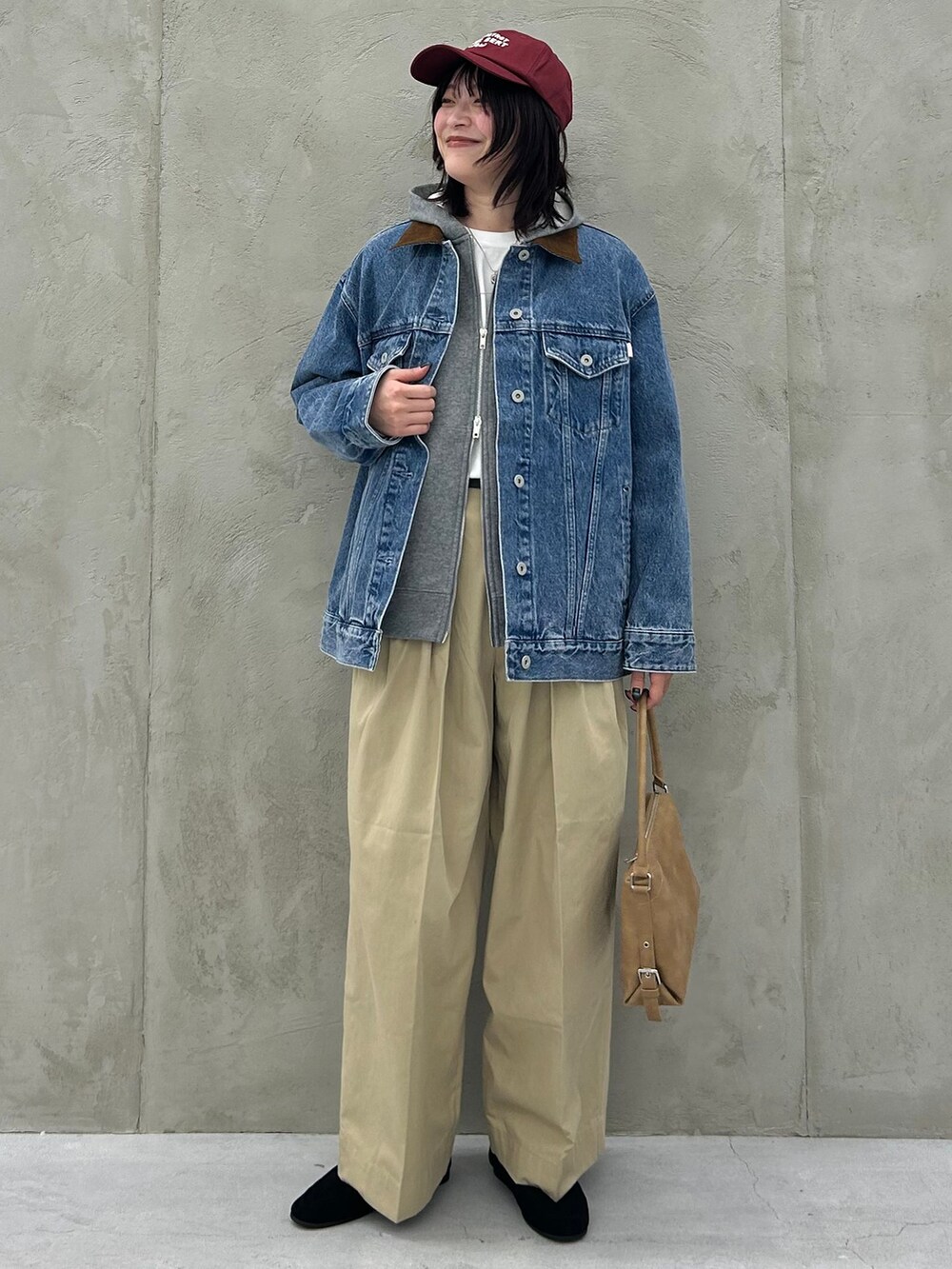 ブルー系のデニムジャケット、ベージュ系のチノパンツ、グレー系のパーカーを着用したレディースの冬コーディネートの8枚目の写真