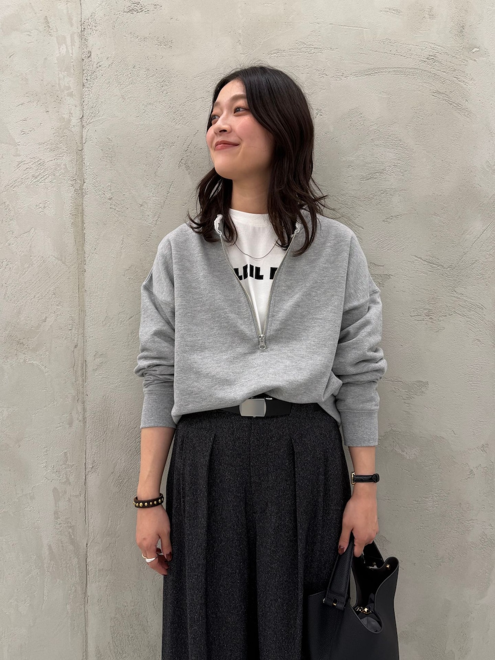 ブラック系のスラックス、ホワイト系のTシャツ/カットソー、グレー系のスウェットを着用したレディースの秋コーディネートの7枚目の写真