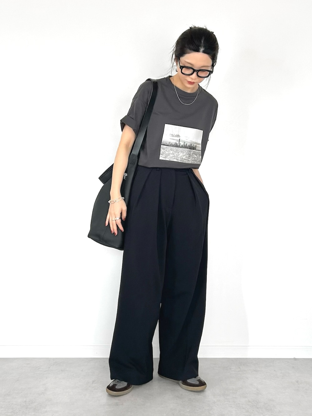 グレー系のTシャツ/カットソー、ブラック系のその他パンツ、ブルー系のスニーカーを着用したレディースの春コーディネートの2枚目の写真