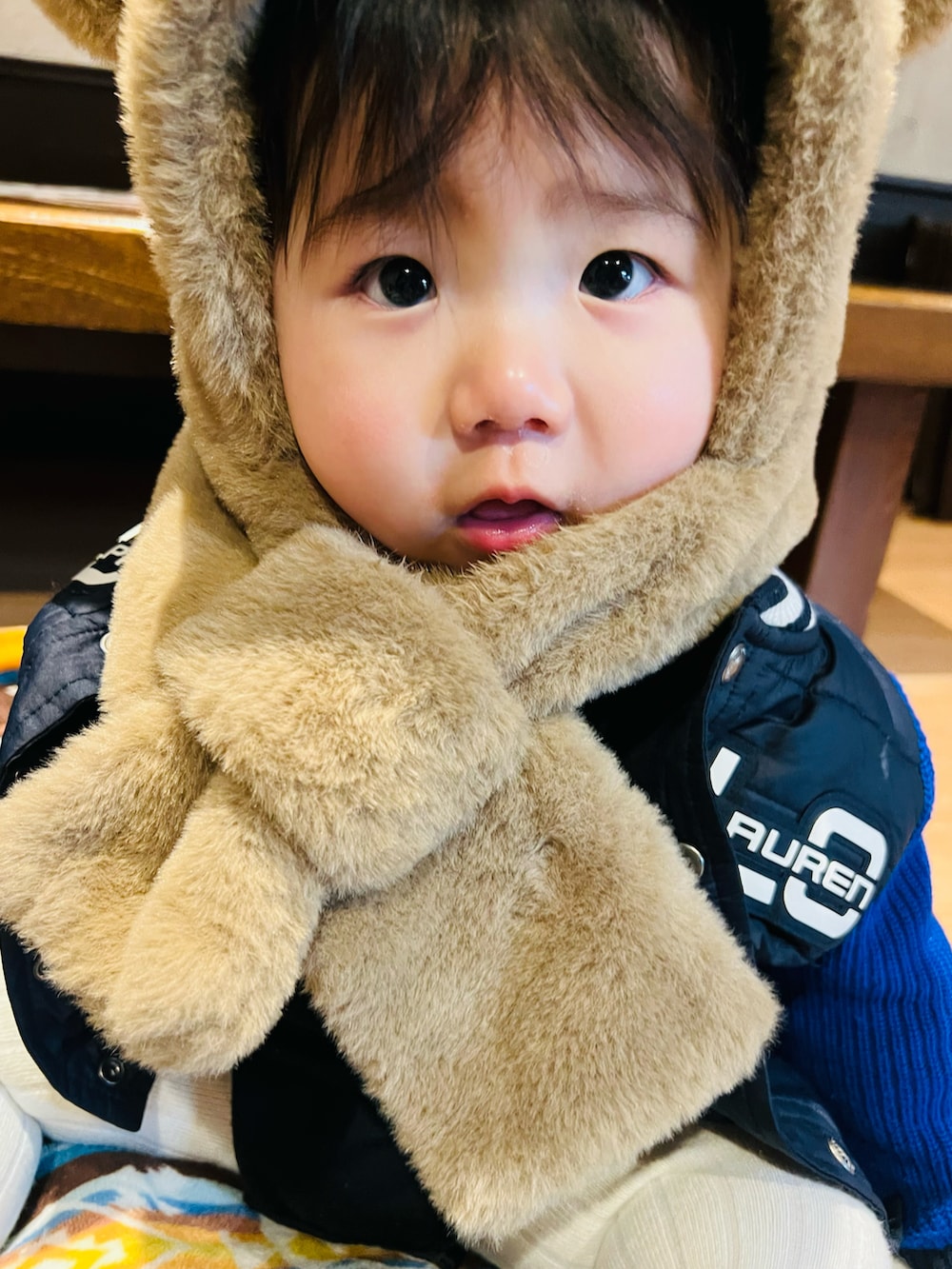 ブルー系のジャケット/アウター、ベージュ系の帽子、ホワイト系のベビーシューズ/ベビーソックスを着用したキッズの冬コーディネートの3枚目の写真