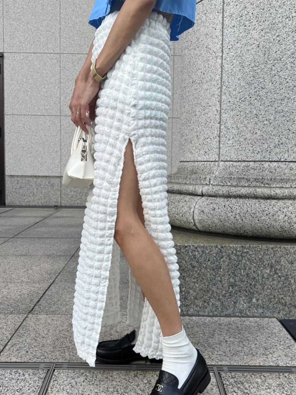 ブルー系のシャツ/ブラウス、ホワイト系のスカート、ホワイト系のショルダーバッグを着用したレディースの秋コーディネートの3枚目の写真