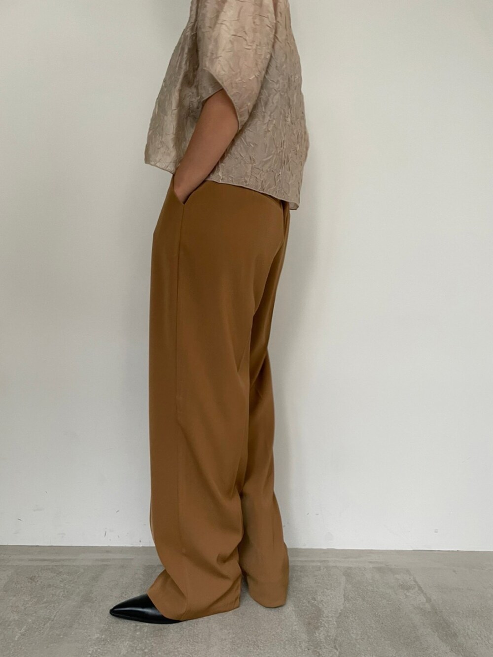 ブラウン系のベスト、ブラック系のショルダーバッグ、ブラウン系のその他パンツを着用したレディースの秋コーディネートの5枚目の写真