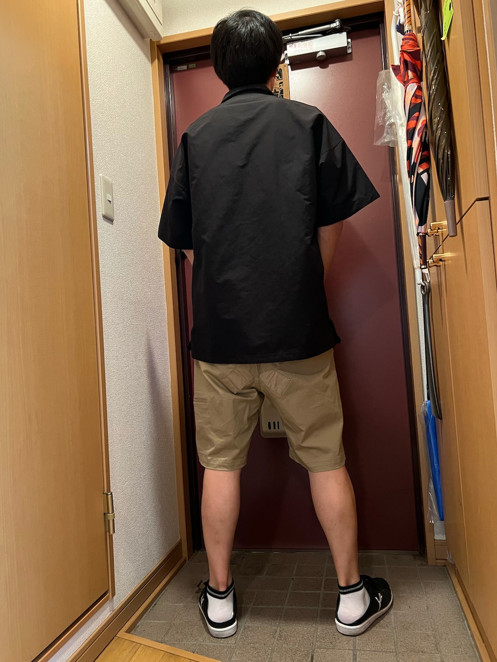 ベージュ系のパンツ、ブラック系のシャツ/ブラウスを着用したメンズの夏コーディネートの2枚目の写真