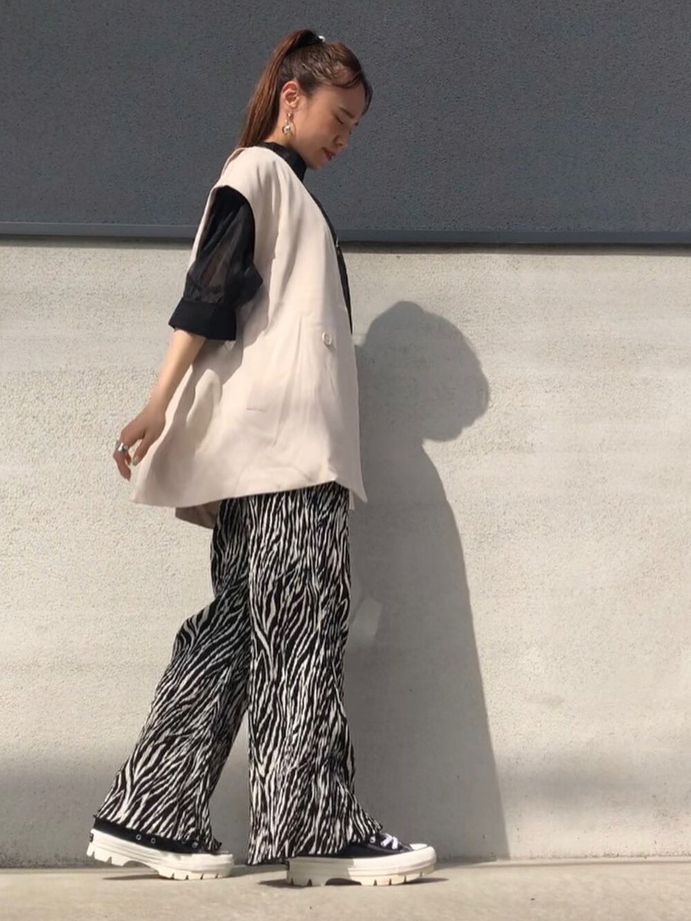 ブラック系のシャツ/ブラウス、ブラック系のパンツ、ブラック系のスニーカーを着用したレディースの春コーディネートの4枚目の写真