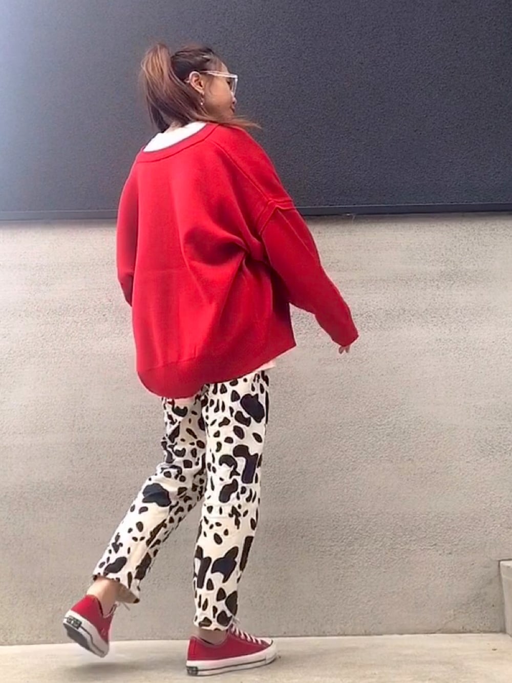 レッド系のカーディガン/ボレロ、ホワイト系のTシャツ/カットソー、ホワイト系のパンツを着用したレディースの秋コーディネートの3枚目の写真