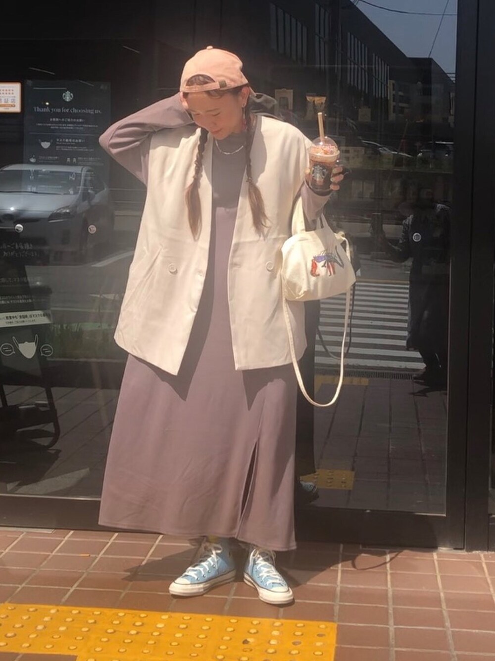 グレー系のベスト、ブルー系のスニーカーを着用したレディースの春コーディネートの3枚目の写真