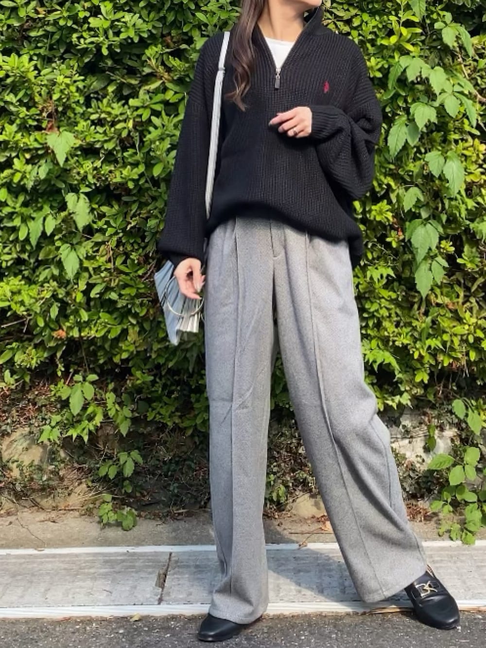 ブラック系のニット/セーター、ベージュ系のパンツを着用したレディースの秋コーディネートの3枚目の写真