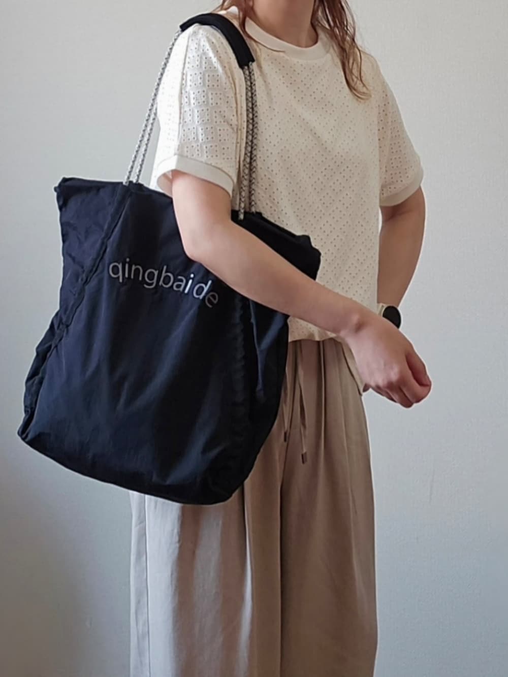 ホワイト系のTシャツ/カットソー、ベージュ系のその他パンツ、ブラック系のトートバッグを着用したレディースの夏コーディネートの4枚目の写真