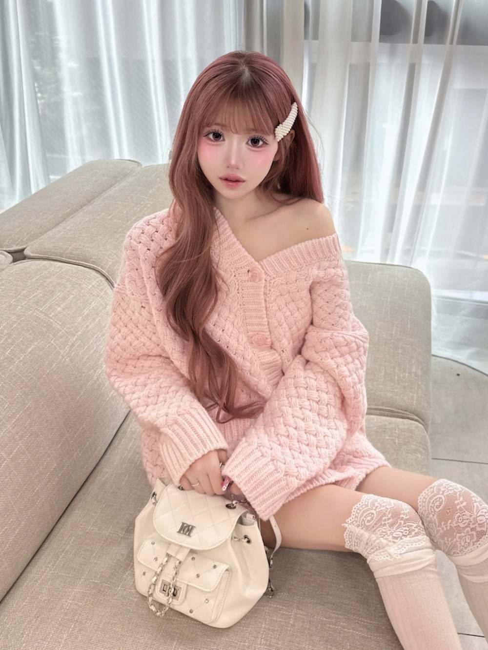 ピンク系のカーディガン/ボレロを着用したレディースの冬コーディネートの3枚目の写真