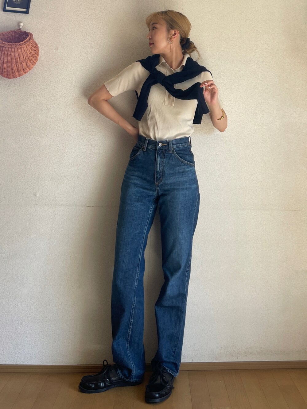 ブラック系のモカシン/デッキシューズ、ブルー系のデニムパンツ、ホワイト系のトップスを着用したレディースの秋コーディネートの2枚目の写真