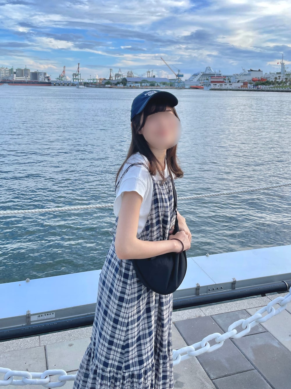 ブルー系のワンピース、ブラック系のバッグを着用したレディースの夏コーディネートの3枚目の写真