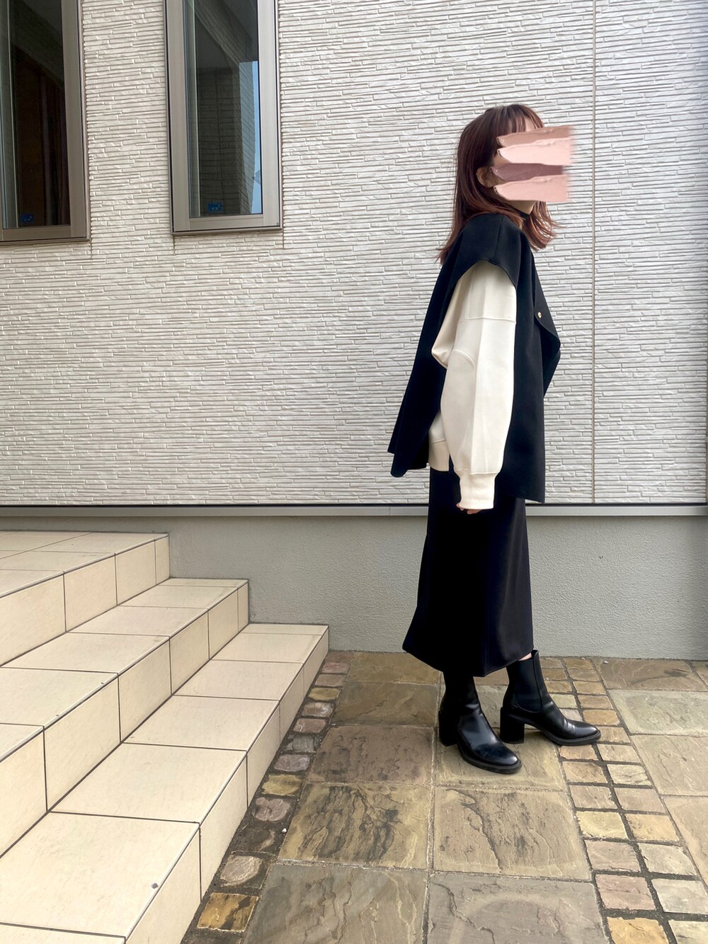 ホワイト系のスウェット、ブラック系のブーツを着用したレディースの冬コーディネートの2枚目の写真